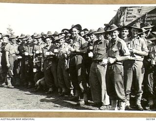 DUMPU, RAMU VALLEY, NEW GUINEA. 1944-01-03. TROOPS OF THE 2/12TH INFANTRY BATTALION ENJOYING A CUP OF TEA AT THE YOUNG MEN'S CHRISTIAN ASSOCIATION HUT AT DUMPU