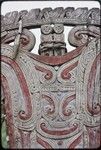 Canoes: detail of carved and painted splashboard of kula canoe, includes two witch figures (top)