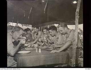 MOMOTE, LOS NEGROS ISLAND, ADMIRALTY ISLANDS, C. 1944-04. 76 KITTYHAWK SQUADRON. LUNCH AFTER THE HARD MORNING'S WORK IS NO SMALL ITEM. FAST FLYING, HARD FIGHTING AND HIGH ALTITUDE SERVE TO WHET THE ..