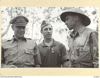 1942-11-28. NEW GUINEA. LIEUT. GENERAL GEORGE KENNY JUST AFTER DECORATING 2ND LIEUT. VICTOR FRANCO, ROCHESTER, PENN., WITH SILVER STAR AND SQUADRON COMMANDER WILLIAM BENN, WASHINGTON PENN., WITH ..