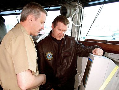 CAPT William J. Luti, Commanding Officer of the amphibious assault ship USS GUAM (LPH 9), explains some of the ship's navigation equipment to Secretary of Defense William S. Cohen during his visit to the ship. Guam was one of many stops the Cohens made throughout Europe where they celebrated the holidays with some of the over 230,000 service members stationed there