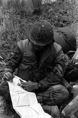 Lieutenant Barber from Company E, 2nd Battalion, 3rd Marine Regiment, 1ST Marine Brigade, briefs his squad leader on up-coming tactics during Operation ZULU WARRIOR. The operation is taking place at the Pakalula Training Area