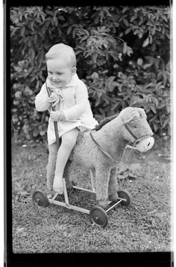 Margaret Hare sitting on a push along toy donkey