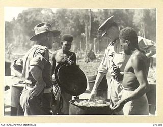 LAE, NEW GUINEA. 1944-10-18. NX201 MAJOR H.E. GALE, MBE, CAMP COMMANDANT, 2ND AUSTRALIAN CORPS (1) AND NGX350 MAJOR E.W. JENYNS, DEPUTY ASSISTANT DIRECTOR OF NATIVE LABOUR AND OFFICER- IN- CHARGE, ..