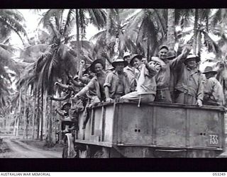 MILNE BAY, NEW GUINEA. 1943-06-29. GANG OF DOCKERS FROM "C" GROUP, 2/3RD AUSTRALIAN DOCKS OPERATING COMPANY, ROYAL AUSTRALIAN ENGINEERS, LEAVING CAMP AREA FOR THE DOCKS. SHOWN: SERGEANT (SGT) G. ..
