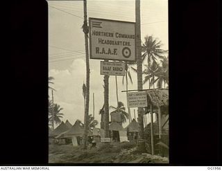MADANG, NEW GUINEA. C. 1944-10. SIGN ON THE ENTRANCE OF NORTHERN COMMAND HQ RAAF SHOWING THE WHEREABOUTS OF RAAF RADIO STATION "THE VOICE OF THE ISLANDS"