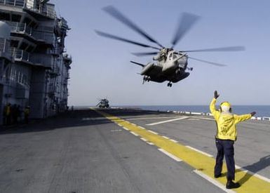 U.S. Navy Aviation Boatswain's Mate Handler Third Class Theodore Nkwocha signals to an MH-53E Super Stallion helicopter that it is clear to depart the flight deck of the Tarawa Class Amphibious Assault Ship USS SAIPAN (LHA 2) during operations in the Gulf of Aden on Sept. 7, 2006. SAIPAN is currently underway conducting maritime security operations in the Persian Gulf. (Mass Communication SPECIALIST SEAMAN Patrick W. Mullen III) (Released)