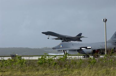 A US Air Force (USAF) B-1B Lancer aircraft takes off at Andersen Air Force Base (AFB), Guam, in support of Operation ENDURING FREEDOM. A second B-1B is visible in the foreground