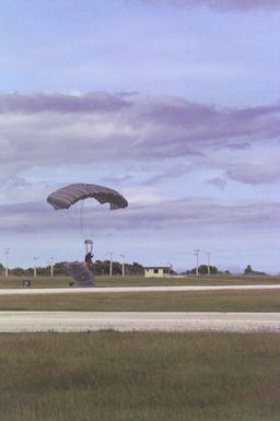 Two US Marines, 2nd Platoon, Company A, 5th Force Reconnaissance Battalion, 3rd Marine Division, land safely with the MC5 parachutes on the drop zones after they jumped from US Air Force C-141 Starlifter (Not shown) at 6000 feet above sea level during the Force Reconnaissance Exercises at Andersen Air Force Base, Guam