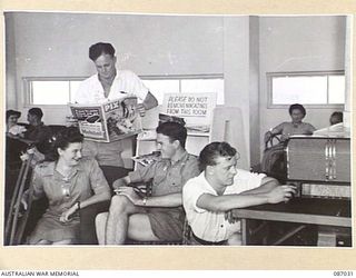 SYDNEY, NSW. 1945-02-27. PATIENTS AT 113 GENERAL HOSPITAL (CONCORD), ENJOY AMENITIES PROVIDED BY THE RED CROSS SOCIETY IN THE LOUNGE. THEY AWAIT THE ARRIVAL OF VISITORS. IDENTIFIED PERSONNEL ARE:- ..