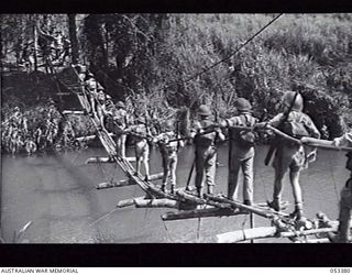 DONADABU, SOGERI VALLEY, NEW GUINEA. 1943-06-28. TROOPS OF "B" COMPANY, 25TH INFANTRY BATTALION CROSSING CATWALK SUSPENSION BRIDGE, AN "A" TYPE BRIDBE, DURING TRAINING EXERCISE