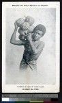 Young man carrying fruit of a breadfruit tree, Fiji, ca.1900-1930