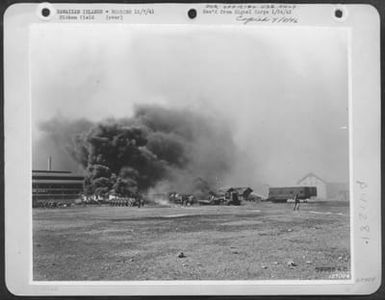 One Of The First Army Photos Of The Bombing Of Hickam Field, T.H., Dec. 7, 1941. Fireman Preparing To Attempt To Extinguish Oil Flames At Hickam Field, Hawaii. (U.S. Air Force Number 59988AC)