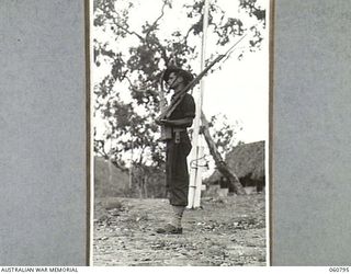 POM POM VALLEY, NEW GUINEA. 1943-11-27. SX16387 PRIVATE H. R. SCOTT, SENTRY, ON DUTY OUTSIDE HEADQUARTERS, 18TH AUSTRALIAN INFANTRY BRIGADE