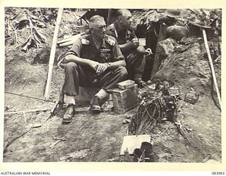 TOROKINA, BOUGAINVILLE, SOLOMON ISLANDS. 1944-12-15. MAJOR GENERAL W. BRIDGEFORD, (1), WITH BRIGADIER J. FIELD, (2), AT LUNCH ON GEORGE HILL DURING AN EXAMINATION OF 9 INFANTRY BATTALION FORWARD ..