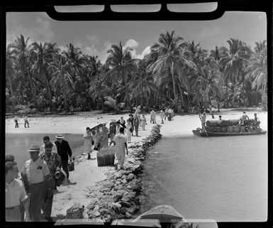 Akaiami, Aitutaki, Cook Islands, tourists ready to board the TEAL (Tasman Empire Airways Limited) Flying boat