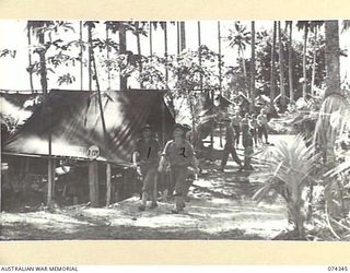 SIAR, NEW GUINEA. 1944-06-25. MEMBERS OF THE WORKING PARTY CLEANING UP IN THE TENT LINES OF D COMPANY, 57/60TH INFANTRY BATTALION. IDENTIFIED PERSONNEL ARE:- VX133031 CAPTAIN W.A. ROSS (1); VX84582 ..