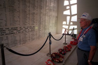 USS ARIZONA crew member Frances M. Falge gazes at USS ARIZONA Memorial wall engraved with the names of his shipmates who perished during Dec. 7, 1941, attack on Pearl Harbor. He and other USS ARIZONA survivors are on a private tour of the memorial following 50th anniversary Remembrance Day ceremonies