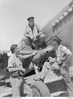 MOROTAI, HALMAHERA ISLANDS, NETHERLANDS EAST INDIES. C. 1945-03. FLIGHT SERGEANT E. QUINN, GUMERACHA, SA, FLYING OFFICER D. C. HUXLEY, BURNSIDE, SA, AND FLYING OFFICER R. B. CRAVEN, NORTH ADELAIDE, ..