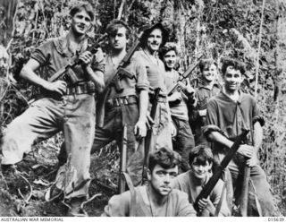 THE SELF NAMED "DEVIL'S OWN" OUTFIT - A GROUP OF AUSTRALIANS WHO HELPED DRIVE THE JAPS FROM MOUNT TAMBU; AND CLEARED THE WAY FOR THE ADVANCE ON SALAMAUA. LEFT TO RIGHT (BACK) CORPORAL DON MATHER OF ..