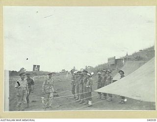 Donadabu, Port Moresby. 1944-01-01. The General Officer Commanding New Guinea Force, Lieutenant General Sir Leslie Morshead, KCB KBE CMG DSO ED, arriving at a 15th Australian Infantry Brigade ..