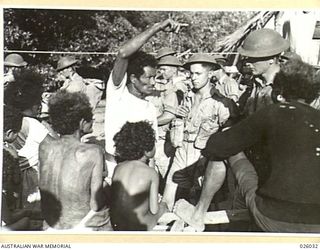 PAPUA, NEW GUINEA. 1942-07. AUSTRALIAN INFANTRY PATROLS IN PAPUA CHECK UP ON ANY SIGNS OF JAPANESE INFILTRATION. PAPUAN NATIVES IN A COASTAL VILLAGE ARE SHOWN BEING QUESTIONED REGARDING THE MOST ..