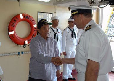 Republic of the Philippines Consul General, The Honorable Ariel Abadilla (foreground left) is greeted by US Navy (USN) Captain (CAPT) Joseph L. Moore Commanding Officer, Medical Training Facility, aboard the USN Military Sealift Command (MSC), Hospital Ship, USNS MERCY (T-AH 19), during a visit at Navy Base Pearl Harbor, Hawaii (HI). The USNS MERCY is starting a scheduled five-month deployment to deliver aid and humanitarian assistance to the Pacific Islands, and Southeast Asia