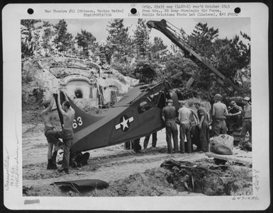 Mechanics Put Landing Gear On A Vultee L-5's Of The 163Rd Liaison Squadron Attached To The 10Th Army. The Plane Has Just Been Uncrated At Cub Field No. 7 On Okinawa, Ryukyu Retto, After Shipment From Hawaii. 1945. (U.S. Air Force Number 64714AC)