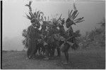 Pig festival, stake-planting, Tuguma: decorated men dance, sing and play kundu drums