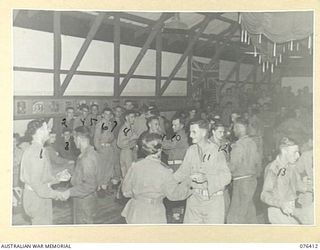 LAE, NEW GUINEA. 1944-10-03. GUESTS ENJOYING A DANCE IN THE NEW RECREATION HALL OF THE 22ND WORKS COMPANY. IDENTIFIED PERSONNEL ARE:- V301142 PRIVATE W.R. BARRY (1); N167844 PRIVATE G.M. BEACH (2); ..