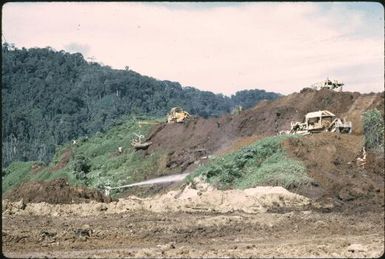 Disposing of the overburden: sluicing into the pinei river (3) : Bougainville Island, Papua New Guinea, April 1971 / Terence and Margaret Spencer