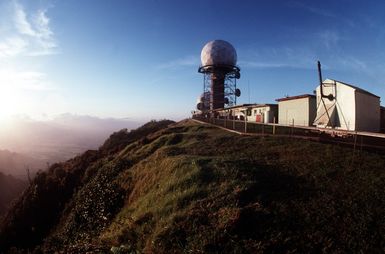 The sun rises over the mountain range near the 169th Aircraft Control and Warning Squadron (169th ACWS) radar site