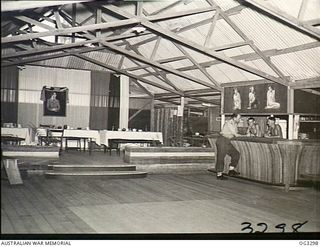 TOROKINA, BOUGAINVILLE ISLAND, SOLOMON ISLANDS. 1945-08-25. INTERIOR OF THE OFFICERS MESS, NO. 7 AIRFIELD CONSTRUCTION SQUADRON RAAF. 128246 FLYING OFFICER A. E. SMITH OF CARNEGIE, VIC, WHO IS MESS ..