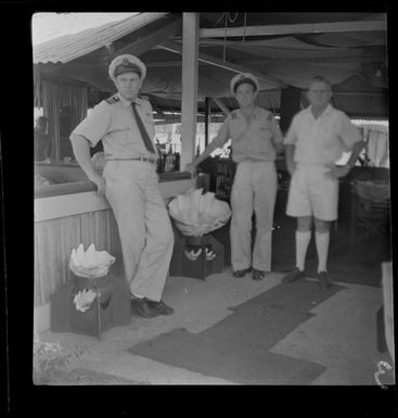 From left - Captain W Forgan Smith (1st Officer), L Purkiss (Qantas), Mr G Tyrell at Tyrell's house, Madang, Papua New Guinea
