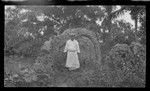 Portrait of man, standing in front of possible shrine