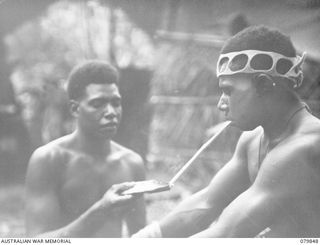 RILE, NEW BRITAIN. 1945-03-15. MARIMBO (1), AND NAROL (2) MEMBERS OF THE 1ST NEW GUINEA INFANTRY BATTALION PAUSE FOR A "SMOKO"