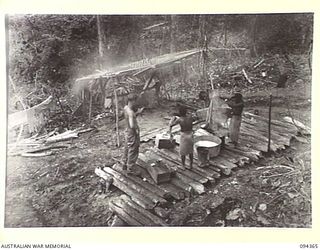 YAMIL 2, NEW GUINEA. 1945-07-20. THE MAIN DRESSING STATION, 2/2 FIELD AMBULANCE, ESTABLISHED DOWN THE SLOPES OF YAMIL 2. EACH DAY IS WASH DAY AT THE HOSPITAL AND A FULL TIME JOB. PRIVATE D.R. ..
