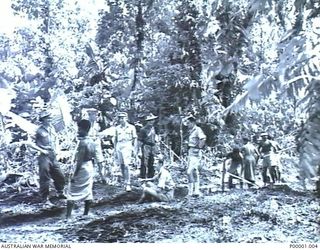 THE SOLOMON ISLANDS, 1945-01-09. AUSTRALIAN AND NEW ZEALAND SERVICEMEN WITH NATIVE LABOURERS AT A COMBINED FORCES TRAINING CAMP. (RNZAF OFFICIAL PHOTOGRAPH.)