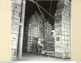 LAE, NEW GUINEA. 1944-09-27. A MEMBER OF THE STAFF OF THE 43RD FIELD ORDNANCE DEPOT PREPARING CASES OF FOOD FOR SHIPMENT TO THE VARIOUS UNITS ALONG THE COAST