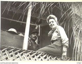 ALEXISHAFEN, NEW GUINEA. 1944-08-31. NX15943 LIEUTENANT J.S. CLEARY, AUSTRALIAN MILITARY HISTORY SECTION (1) INTERVIEWING MISS FRANCIS LANGFORD, A FAMOUS AMERICAN SINGER (2) AND A MEMBER OF THE BOB ..
