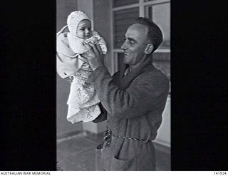 Heidelberg, Vic. 1943-10-06. Sapper Neil Smith, wounded serviceman from New Guinea, tries to amuse his niece, Thelma Wooley, during her visit to the 115th Australian General Hospital