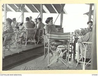 PORT MORESBY, PAPUA, NEW GUINEA. 1944-02-20. AUSTRALIAN ARMY MEDICAL WOMEN'S SERVICE MEMBERS AND ESCORTS IN THE LOUNGE OF THE AUSTRALIAN WOMEN'S SERVICES CLUB, CONDUCTED BY THE AUSTRALIAN ARMY ..