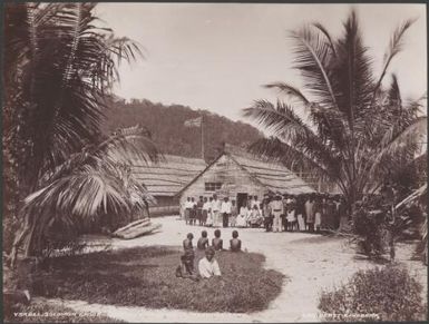 Local people standing in front of Dr. Welchman's house at Mara-na-tabu, Ysabel, Solomon Islands, 1906 / J.W. Beattie