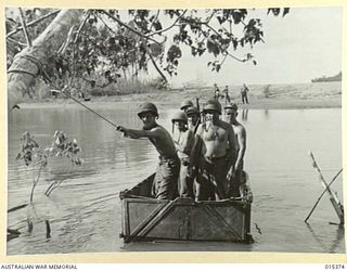 1943-07-31. ALLIED CAPTURE OF MUBO. AMERICAN INFANTRY CROSSING A CREEK NEAR NASSAU BAY, EN ROUTE TO THE FRONT LINE. FROM NASSAU BAY THE AMERICANS AND AUSTRALIANS WENT FORWARD TO CAPTURE MUBO. ..