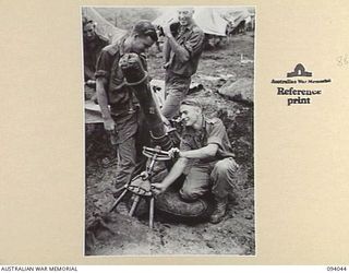 ULEBILUM, NEW GUINEA, 1945-07-11. TROOPS OF A COMPANY, 2/5 INFANTRY BATTALION, IN THEIR WEAPON PIT SIGHTING UP ON KULAURU MISSION READY TO PROVIDE SUPPORTING FIRE. IDENTIFIED PERSONNEL ARE:- PTE ..