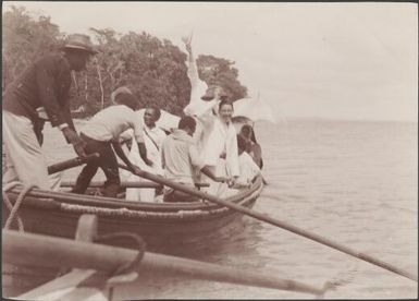 Bishop Wilson and Southern Cross passengers on rowboat farewelling Mara-na-tabu, Solomon Islands, 1906, 1 / J.W. Beattie