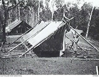 ORO BAY, NEW GUINEA. 1943-04. PERSONNEL OF 10TH FIELD AMBULANCE BUILDING NEW WARDS BY BRIGADING 3 RD, 180 POUND (12 X 14) TENTS. THE SIDES OF THE TENTS WERE PULLED RIGHT OUT AND THE FLYS WERE USED ..