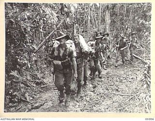 MOUNT SHIBURANGU, WEWAK, NEW GUINEA, 1945-07-13. PERSONNEL OF B COMPANY, 2/8 INFANTRY BATTALION MOVING UP TO THE NEW BIVOUAC AREA READY TO SUPPORT "A" COMPANY N ITS ASSAULT ON "THE BLOT"