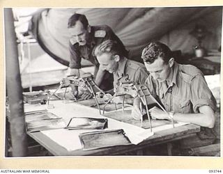 WEWAK AREA, NEW GUINEA, 1945-07-03. CAPTAIN C.E.H. RICH (1); BRIGADIER D. WARNER (2); BRIGADIER A. TYNDALL (3), MEMBERS OF BATTERY COMMAND POST, 2/6 SURVEY BATTERY, ROYAL AUSTRALIAN ARTILLERY, ..