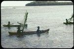 Children in canoes with large leaves